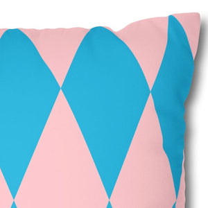 Decorative pillow with blue and pink diamond pattern on a white background
