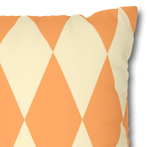 Decorative pillow with orange and beige geometric pattern on a white background