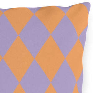 Decorative pillow with orange and purple diamond pattern on a white background