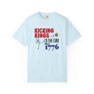 Light blue t-shirt with 'Kicking Kings to the Curb since 1776' text and graphics on a white background.