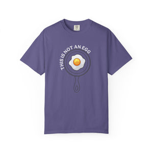 Purple t-shirt with an egg graphic on white background