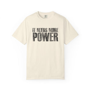 Beige t-shirt with 'IT NEEDS MORE POWER' text on a white background