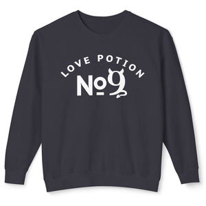 Person wearing a black sweatshirt with 'Love Potion No 9 Halloween' design on a plain background