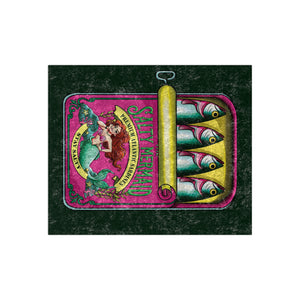 A styled blanket featuring a mermaid illustration and the words 'Salted Avenues' alongside three fish graphics, centered on a dark textured background.
