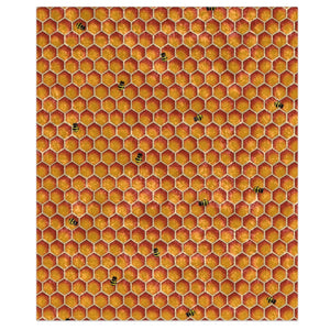 A plush throw blanket with a honeycomb pattern featuring bee motifs in a multicolored design, displayed on a white background.