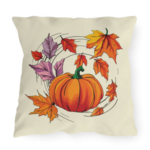 Outdoor throw pillow with a light yellow background featuring a pumpkin and various colorful leaves arranged in a circular pattern.