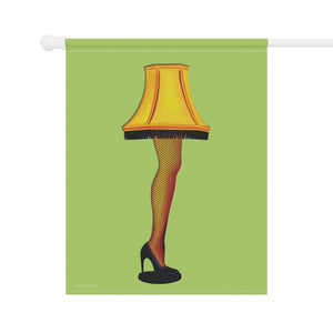 A vertical garden flag hanging from a white rod, featuring a graphic illustration of a lamp shaped like a woman's leg in fishnet stockings and a black high heel, set against a solid light green background.