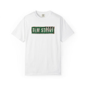 A white short-sleeve crewneck t-shirt featuring a distressed green 'ELM STREET' sign graphic printed on the chest.