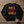 Flat lay image of The back of a black sweatshirt that says Rock the World and a coffee cup next to it.