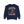 A navy blue crewneck sweatshirt featuring a Halloween graphic of a skeleton jumping over crossed hockey sticks, surrounded by falling autumn leaves, with the text 'IT'S THE MOST WONDERFUL TIME OF THE YEAR'.