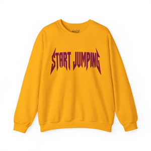 A yellow crewneck sweatshirt with the words 'START JUMPING' printed across the chest in a stylized dark red font, displayed on a clean white background.