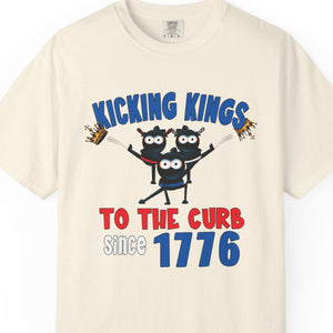 Beige t-shirt with patriotic No Kings cartoon design and text Kicking Kings to the Curb since 1776 on a white background