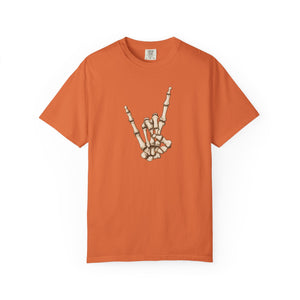 An orange short-sleeve crewneck t-shirt featuring a graphic of a skeleton hand making the rock on paper gesture on the chest, displayed against a solid white background.