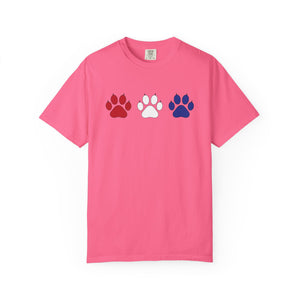 Pink t-shirt with red, white, and blue paw prints on a white background