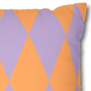 Decorative pillow with purple and orange diamond pattern on a white background