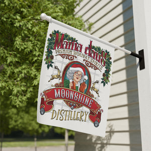 Decorative flag for Mama Claus Moonshine Distillery on a building exterior.