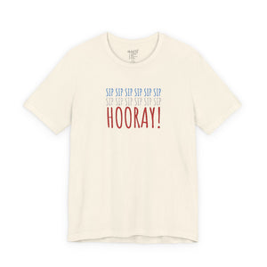 Beige t-shirt with embroidered red white and blue text design on a white background