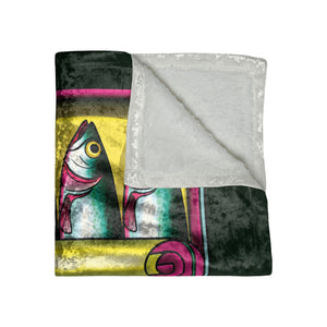 A folded throw blanket featuring a colorful fish illustration on one side and a soft white sherpa fleece lining on the reverse, shown against a plain white background.