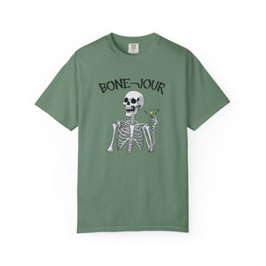 Green t-shirt with a graphic of a skeleton holding a martini with Bone-Jour in bone style lettering at the top.