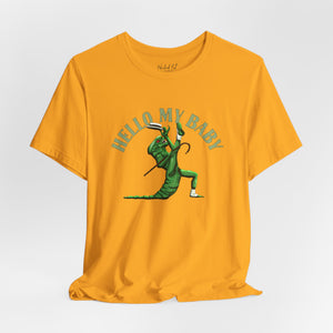 A yellow short-sleeve crewneck t-shirt featuring a green alien dancing, with the text 'HELLO MY BABY' arched above it, displayed on a light gray background.