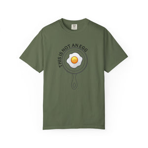 Green t-shirt with a graphic of an egg in a pan on a white background.
