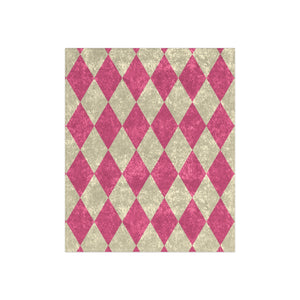 Harlequin patterned throw with pink and beige diamonds on a white background