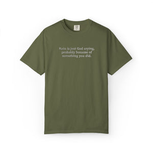 Green t-shirt with 'Rain is just God crying, probably because of something  you did." embroidered text on a white background