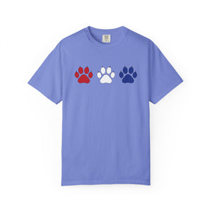 Purple t-shirt with red, white, and blue paw prints on a white background