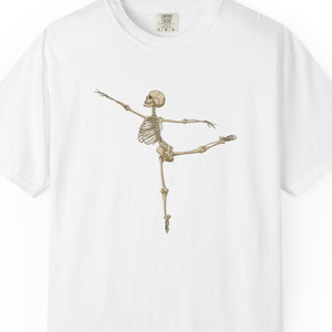 A white short-sleeve crewneck t-shirt featuring a graphic of a dancing skeleton in a ballet pose on the center chest, displayed against a plain white background.