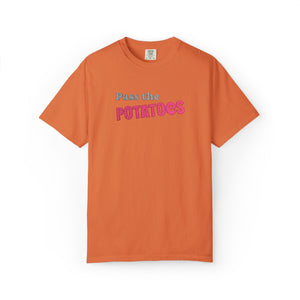 Orange t-shirt with embroidered text that says Pass the Potatoes 