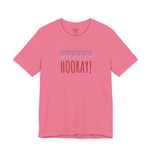 Pink t-shirt with embroidered red white and blue text design on a white background