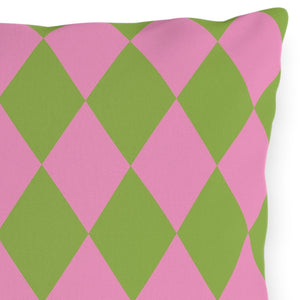 Pink and green diamond patterned pillow on a white background