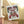 Decorative flag with Santa Claus and moonshine branding on a porch.
