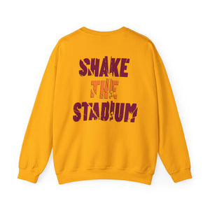 A yellow crewneck sweatshirt shown from the back, featuring the text 'SHAKE THE STADIUM?' printed in a stylized dark red and orange graphic font.