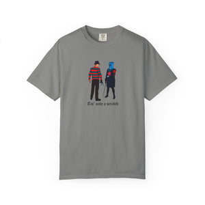 Gray t-shirt with graphic design of two characters and text 'Tis only a scratch' on a white background