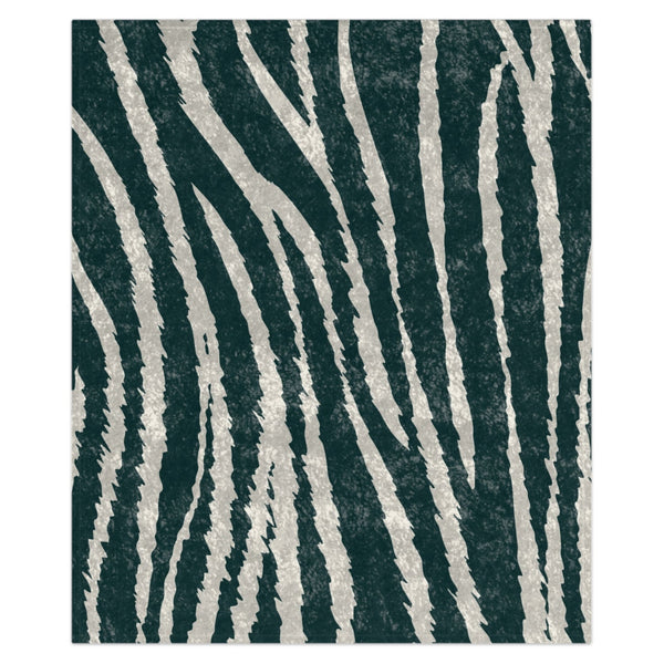 A decorative throw blanket with a zebra stripes pattern on a section and a solid dark color on the rest, displayed on a white background.