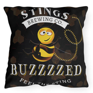 Indoor outdoor accent pillow with a brewery bee theme, featuring a smiling bee holding a chain and the text 'STINGS BREWING CO. BUZZZZED.