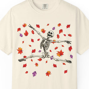 Beige Halloween t-shirt with a skeleton and leaf design on a white background
