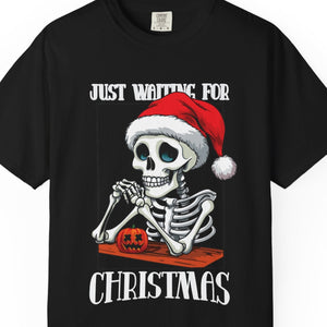 Black t-shirt with skeleton wearing a Santa hat and text 'Just Waiting for Christmas' on a white background