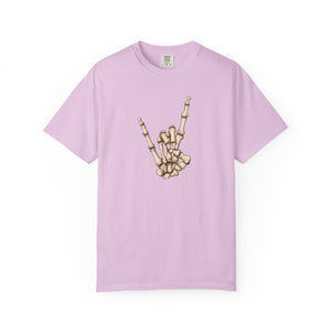 A light purple short-sleeve crewneck t-shirt featuring a graphic of a skeletal hand making the rock on gesture on the chest, displayed against a solid white background.