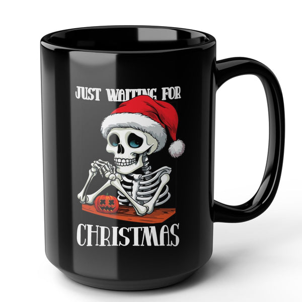Black mug with a skeleton wearing a Santa hat and text 'Just Waiting for Christmas' on a white background