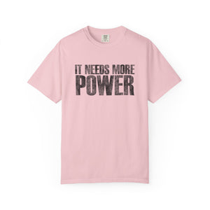 Pink t-shirt with 'IT NEEDS MORE POWER' text on a white background