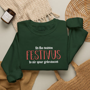 Folded green sweatshirt that reads Festivus tis the season to air your grievances.