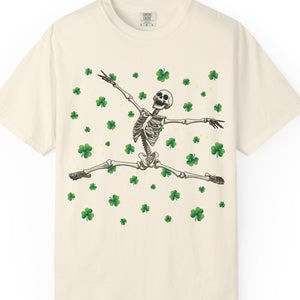 Beige t-shirt with a skeleton and shamrock design on a white background