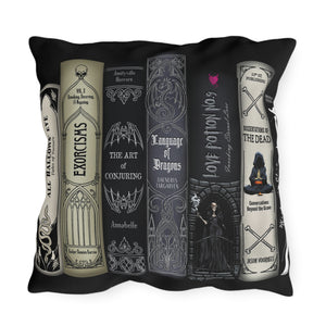 A square black throw pillow featuring a printed graphic of six gothic book spines in cream, gray, and black, with gothic-themed book titles and illustrations.