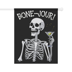 Yard flag and banner with a skeleton holding a martini that says Bone-jour at the top on a black background.