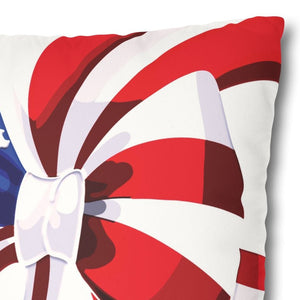 A square-shaped accent pillow with a patriotic red, white, and blue design, featuring a bow in the center.