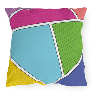 A colorful throw pillow with a geometric pattern featuring comic strip influences, in shades of pink, green, blue, and yellow.