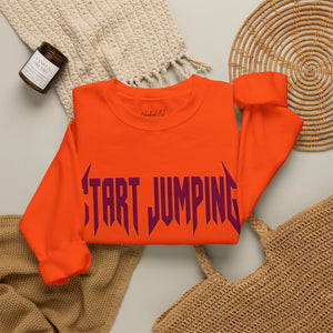Folded orange sweatshirt that says Start Jumping on the front.