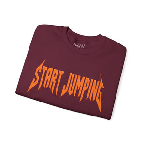 A folded maroon crewneck t-shirt with the words 'START JUMPING' printed across the chest in a stylized orange font, shown on a plain white background.